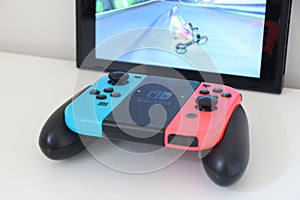 Controller joystick joypad of Nintendo Switch playing video game Mario Kart 8 Deluxe