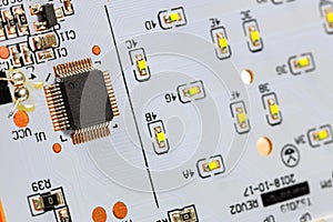 Controller module on LED light module board, electronic circuit panel with surface mount diodes on gray PCB