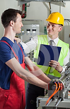 Controller talking with factory worker