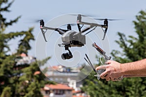 Controlling a remote helicopter drone. Drone flight remote controller in man hands