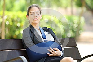 Convalescent businesswoman resting in a park photo