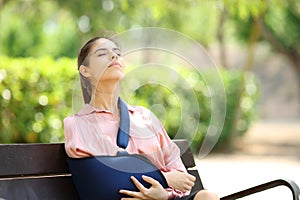 Convalescent woman breathing sitting in a bench photo