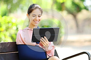 Convalescent woman watching tablet content in a garden photo
