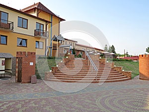 Convenient gently sloping stairs with handrails at the entrance to the hotel`s residential building