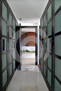 Converging lines of a green walk in wardrobes in a large Spanish villa. photo