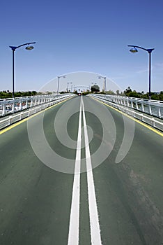 Converging lines of road on bridge