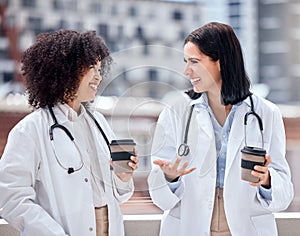 Conversation, coffee and young women doctors talking on medical diagnosis on hospital rooftop. Smile, discussion and