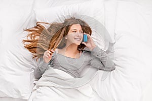 Conversation on phone in bed