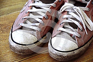 Converse trainers. Popular footwear brand in sneakers and tennis shoes, all star design. Vintage, dirty, worn in pair of cons.