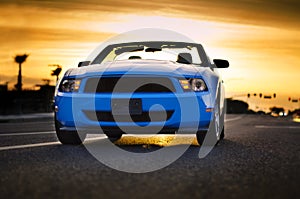 Convertible muscle car sunset background