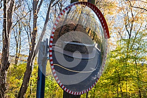 Convex spherical traffic mirror mounted on a winding local road