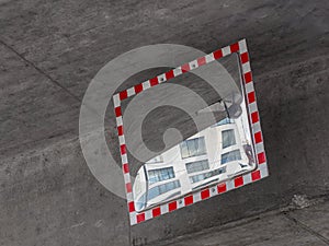 A convex traffic mirror with red-and-white frame