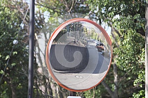 A convex traffic mirror at a road curve