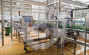 Conveyer belt line loaded with beer bottles in a brewery