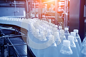 Conveyor belt with bottles of drinking water at a modern beverage plant.