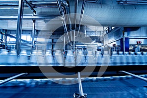 Conveyor belt with bottles of drinking water at a modern beverage plant.