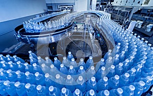 Conveyor belt with bottles of drinking water at a modern beverage plant.