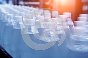 Conveyor belt with bottles of drinking water at a modern beverage plant.