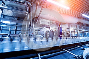 Conveyor belt with bottles of drinking water at a modern beverage plant.