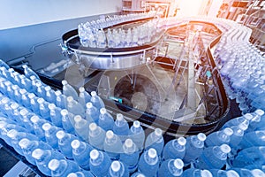 Conveyor belt with bottles of drinking water at a modern beverage plant.