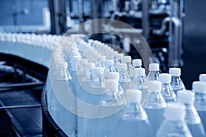 Conveyor belt with bottles of drinking water at a modern beverage plant.