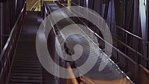 Conveyor belt in a factory of building materials production. Stock footage. Close up of production line with small