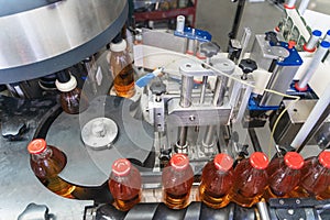 Conveyor belt, juice in glass bottles in automated machine equipment on beverage factory