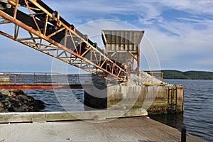 A conveyor belt at a loading dock in the strait of Canso for loading gypsum onto container ships