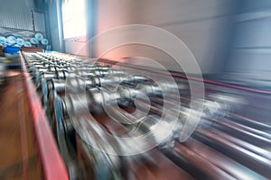 Conveyor belt or production line with blurred motion effect in metalwork manufacturing factory