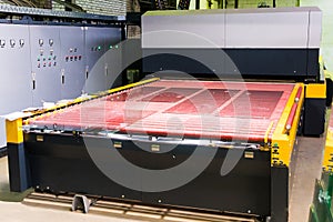 Conveyor belt for production a window pane. Industrial equipment. Process of tempering glass. Machine for heating and