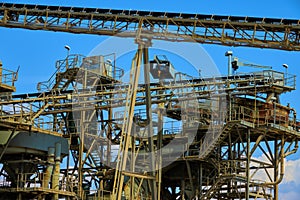 Conveyor belts in front of the collection warehouse of a sand mining company in Germany