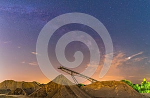 Conveyor bridge at night and milky way, watching the stars at a construction area.