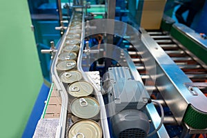 Conveyor for the production of cans in factory. closed tin cans - Canned foods industry. photo