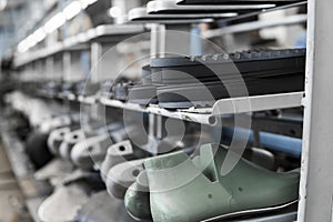 The conveyor on a shoes factory with shoe and sole. Mass production of footwear.