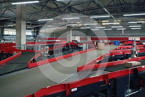 Conveyor sorting belt at distribution warehouse. Distribution hub for sorting packages