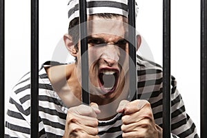 Convict yells through prison bars photo