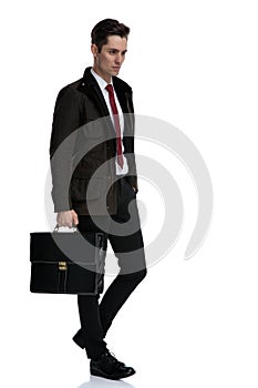 Convinced businessman holding a briefcase