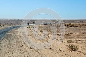 Convoy of 4x4 vehicle drive a dusty desert track in Tunisa
