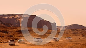 Convoy of tourist vehicles in Monument valley back roads