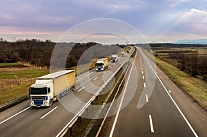 Convoy of transportation trucks on a highway