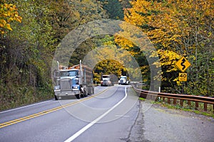 Convoy of trucks on the beautiful autumn highway photo