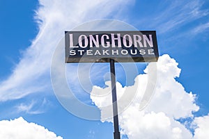 LongHorn Steakhouse sky sign with a blue sky and clouds