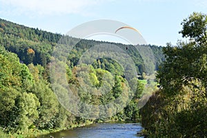 Coo, Belgium - 10 10 2023: paraglider above a river in autumn