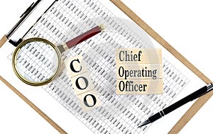 COO - Chief Operating Officer text on wooden block on chart background
