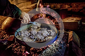 Coocking meet on a wood fire at open place