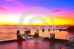 Coogee beach rock pool colourful sunrise.