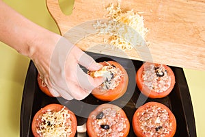 Cook adds cheese to stuffed tomato