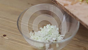 Cook adds cucumber to a salad close-up