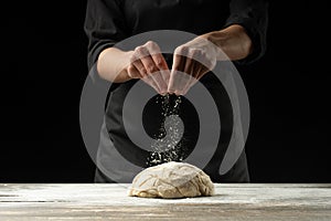 Cook baker prepares bread, focaccia, pizza, buns, sweets. Horizontal photo. Bakery concept, cooking flour products. Design for