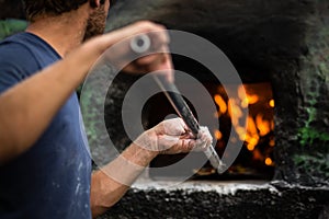 Cook baking pizza in a traditional  oven